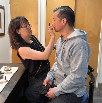 Kung Fu Theater Sijeh Lim assisting Grand Master Wong with makeup