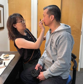Kung Fu Theater Sijeh Lim assisting Grand Master Wong with makeup Kung Fu Theater Sijeh Lim assisting Grand Master Wong with makeup